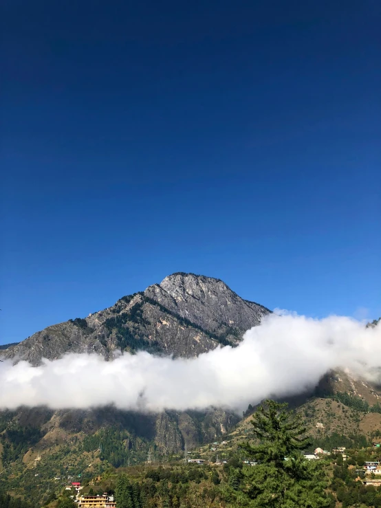 a tall mountain covered in cloud in the background