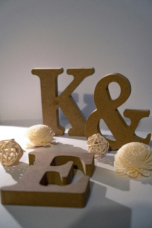 a wooden type with beads for the letters k and o