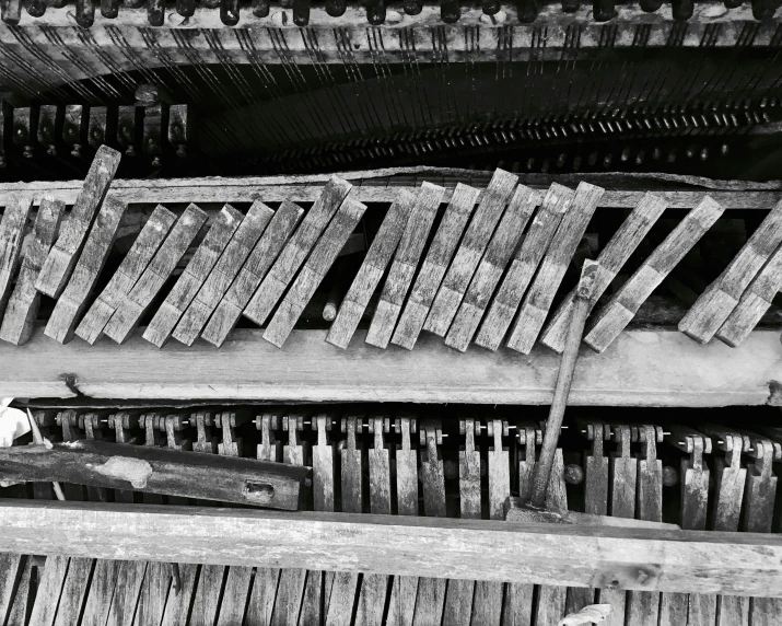 the old piano sits empty as someone puts its arm on it