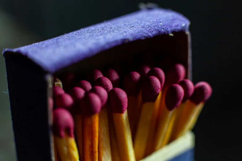 some red and yellow matches sticks are in an empty blue box