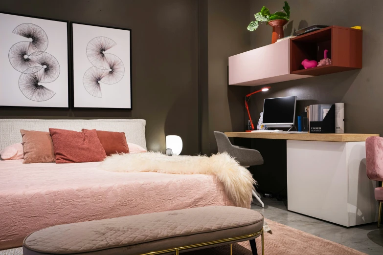 an elegant bedroom with a pink bed and a white desk and a chair