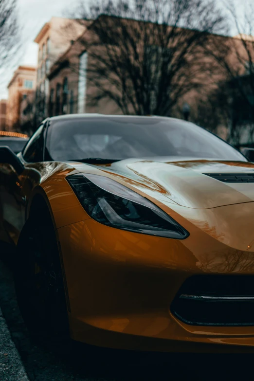 a gold sports car on the street