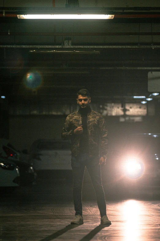 a man standing next to a car in the dark