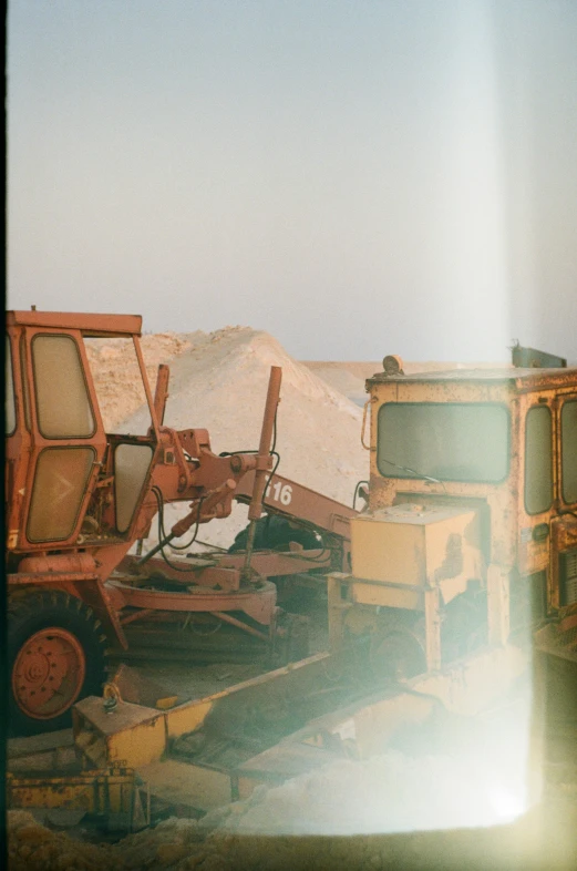 some old machinery that are next to sand