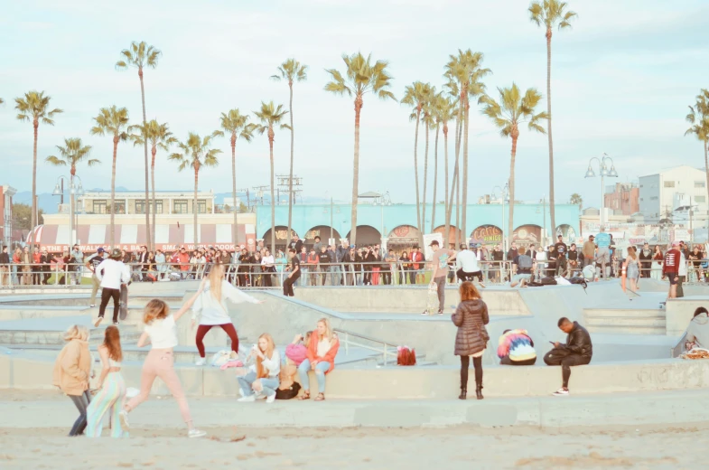 a crowd of people gathered around a skate park