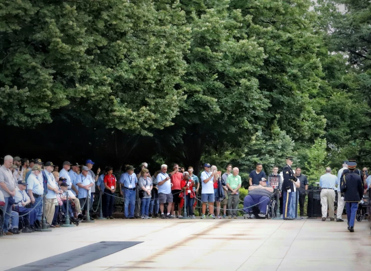 people watch as an elephant walks past them