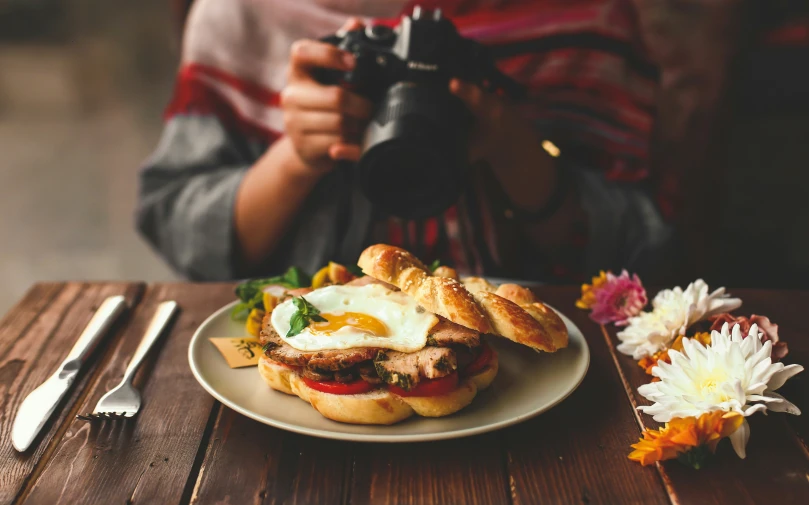 a close up of a person taking pictures of food on a plate