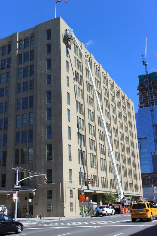 a tall building with many windows next to a street