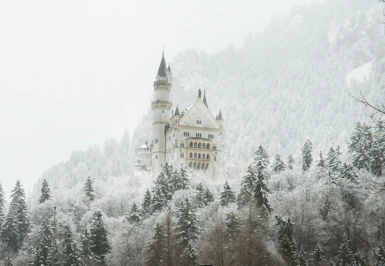 an old castle on a snowy mountain covered in snow