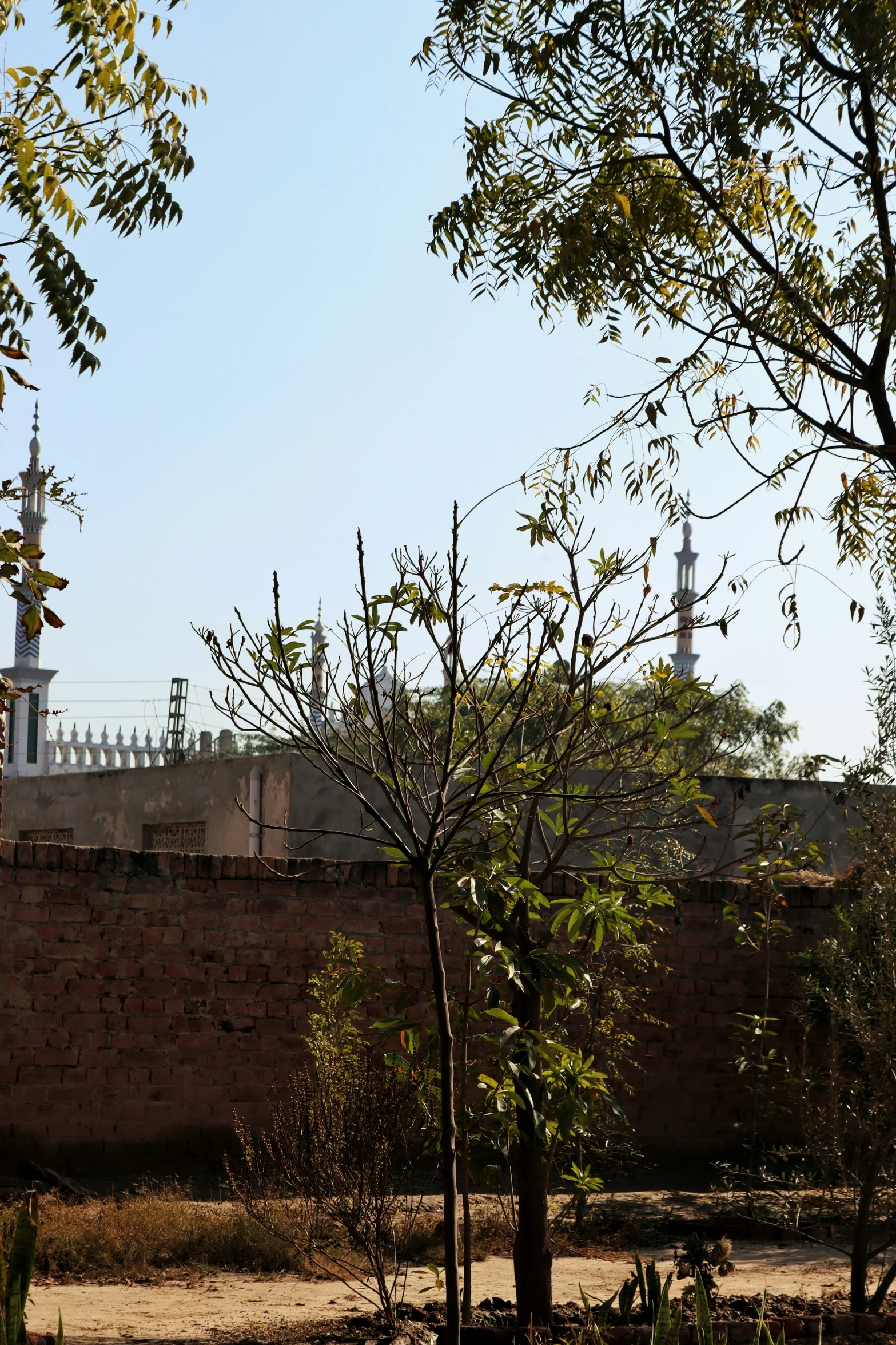 a large brick wall with a fence next to it