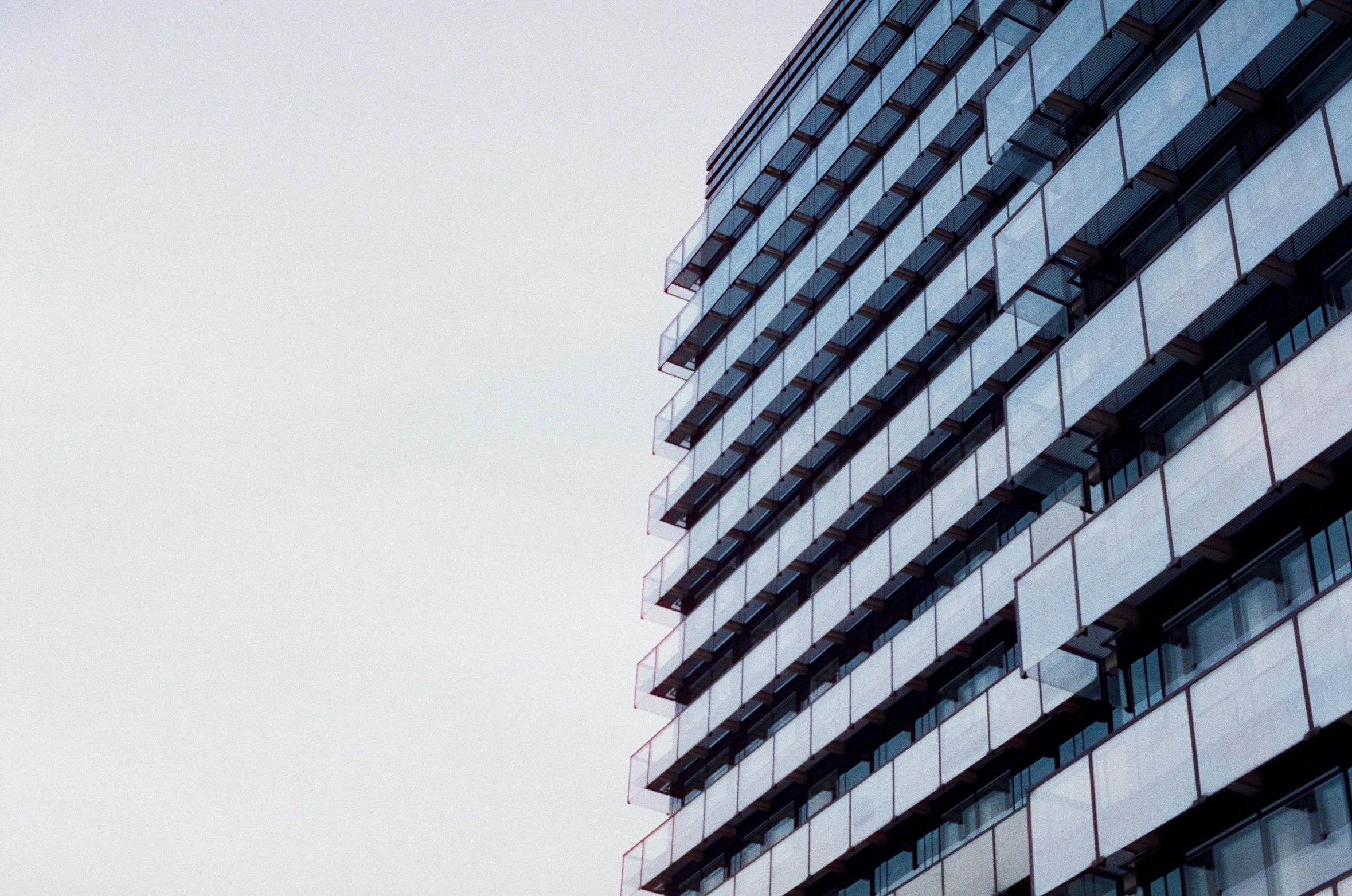 a building with large windows and a sky background