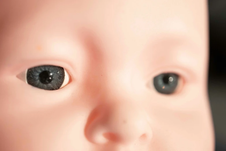 a baby doll with a pair of black contact eyes