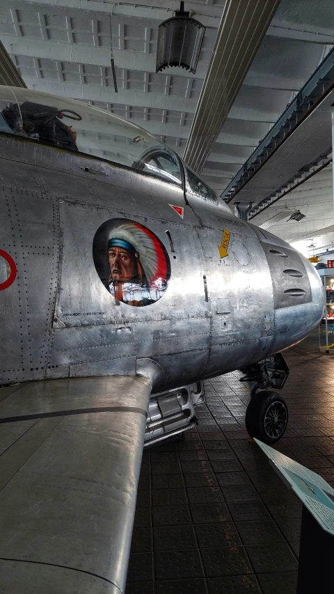 an old looking aircraft is parked in a building