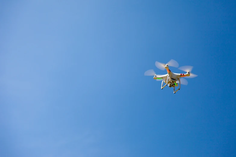 an airplane flying in the blue sky under it