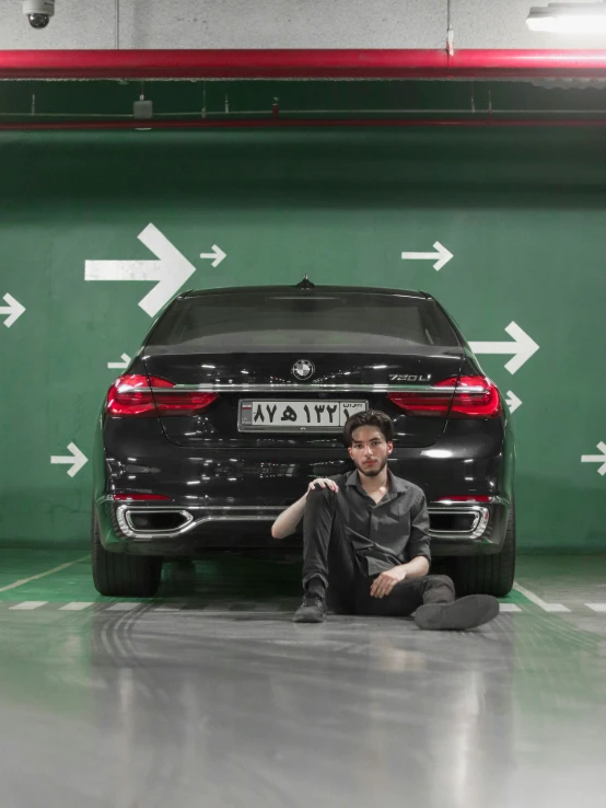 man in front of bmw x7 car at an airport