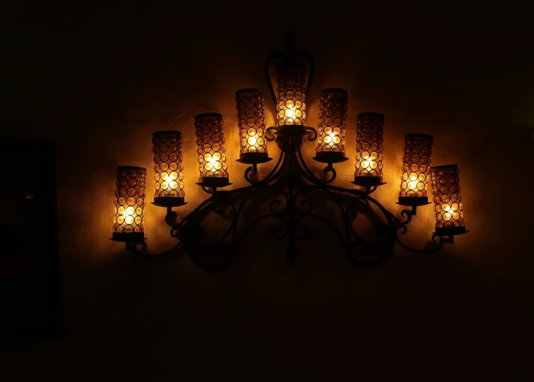 a lit up chandelier with candles inside