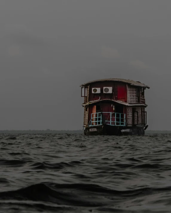 a small floating boat sits on the ocean