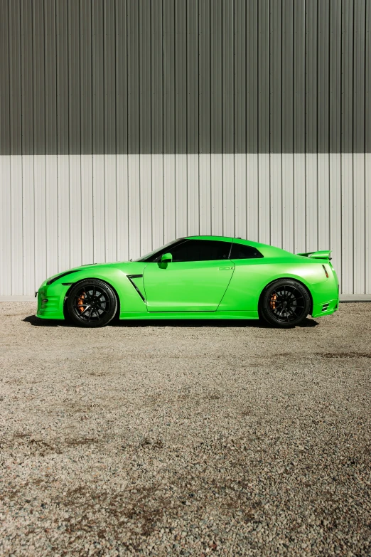 green sports car parked outside in parking lot