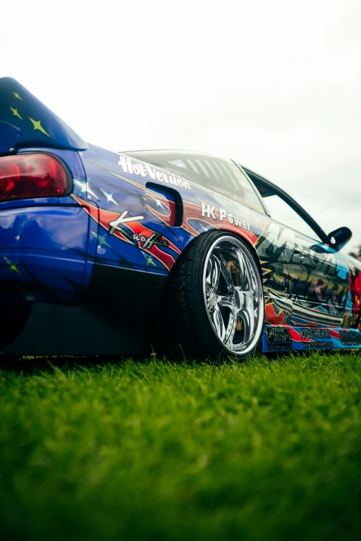 this is a po of a very colorful car parked on the grass