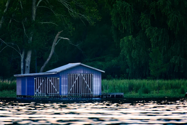 a building next to a lake with trees