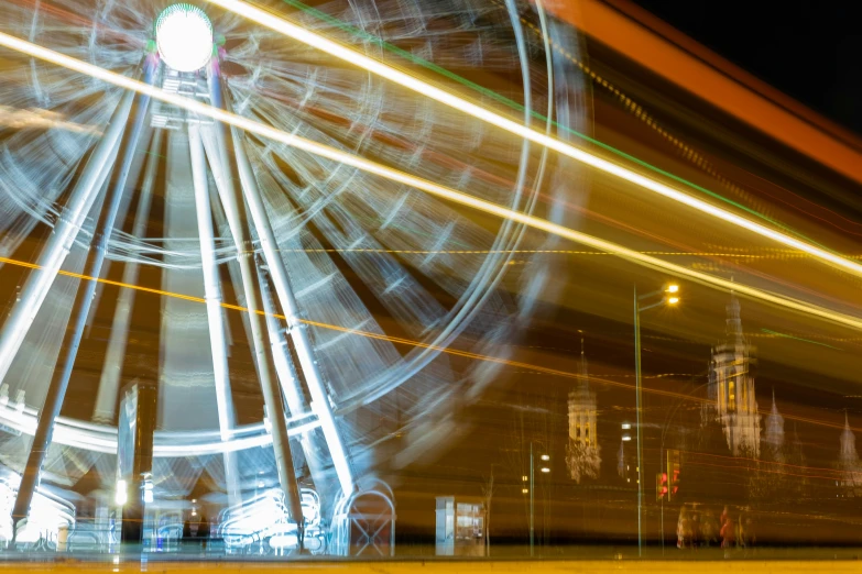 a wheel is moving fast at night with bright lights