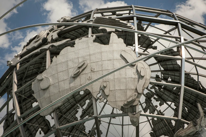 a very large metal clock with a sky background