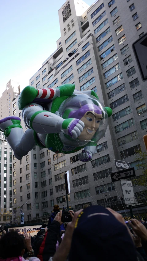 a large balloon of joker is being flown over a crowd