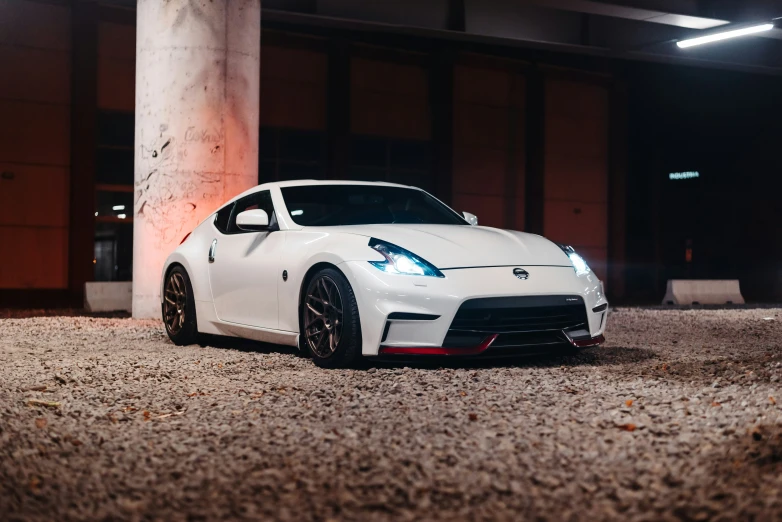 a white sports car parked inside of a garage