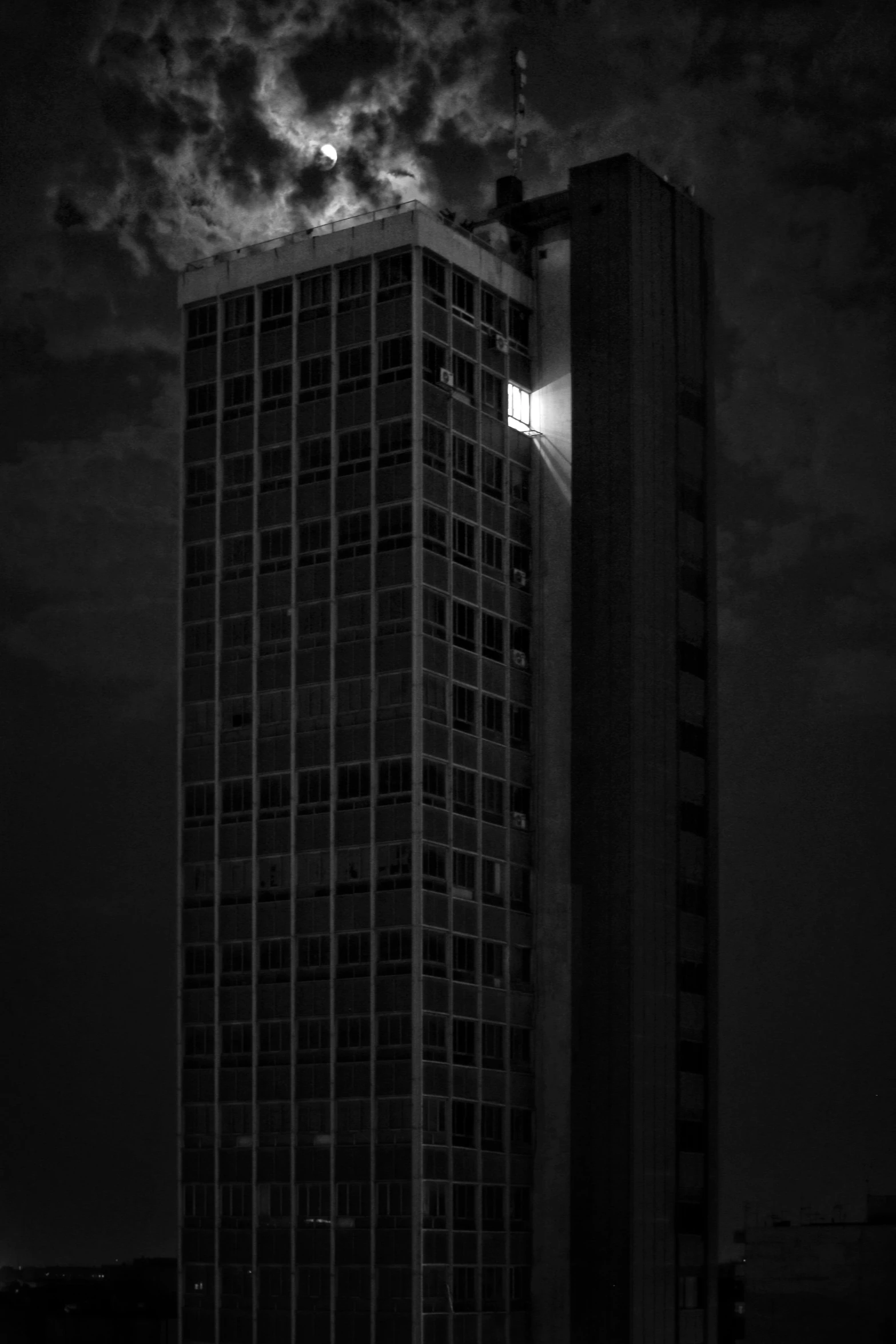 the building is against the dark sky and clouds