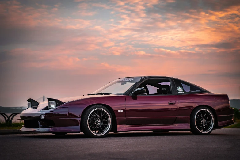 a pink sports car in the sun setting