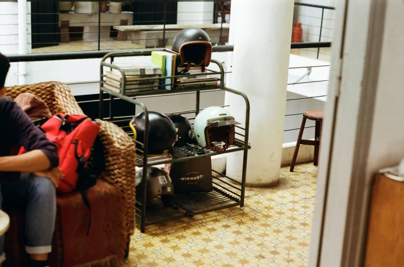 a man sitting on a chair with some leather backpacks