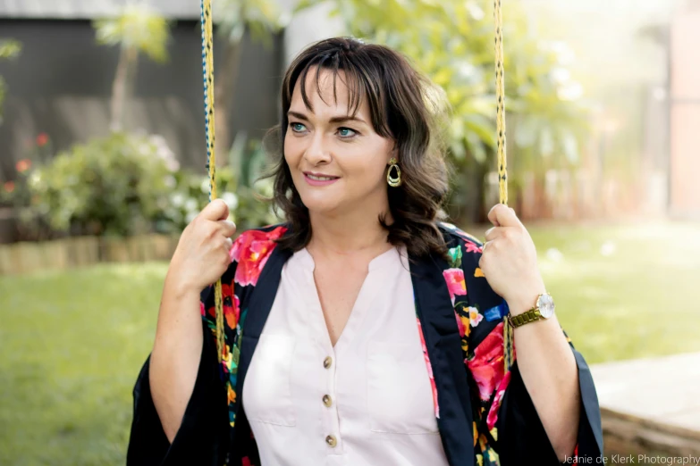 a beautiful woman posing on a swing