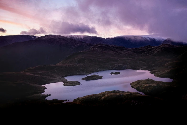 a group of mountains surrounding some small lake