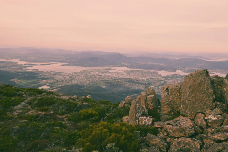 a scenic view from atop a mountain overlooking a city below