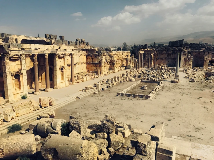 a view of a city with ruins and roman architecture