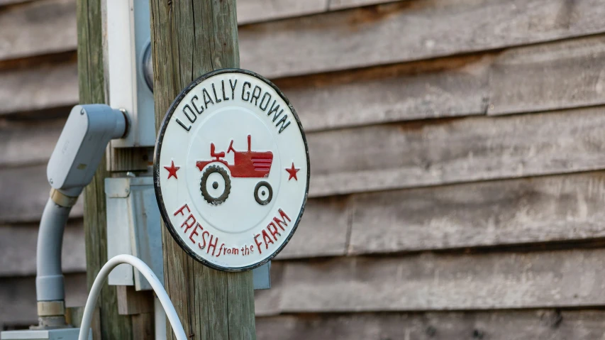 a sign on a wooden pole stating dairy groat farm