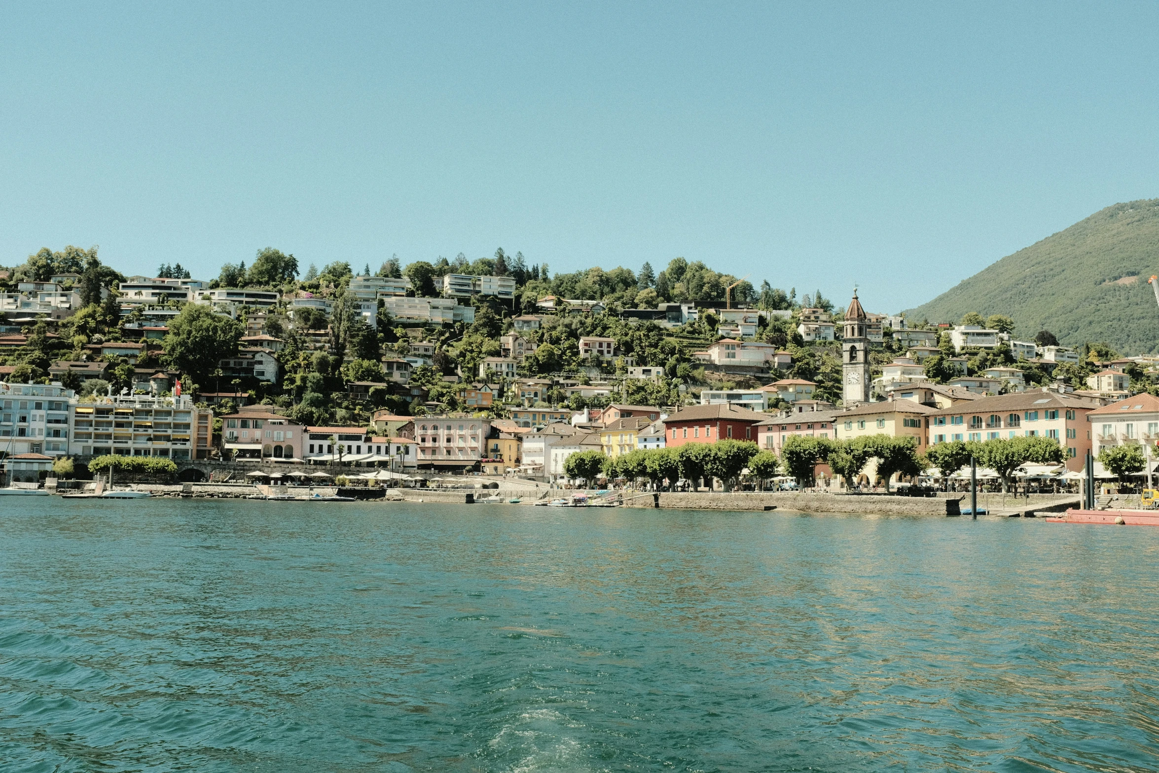 water and buildings sit along the shore of a small town