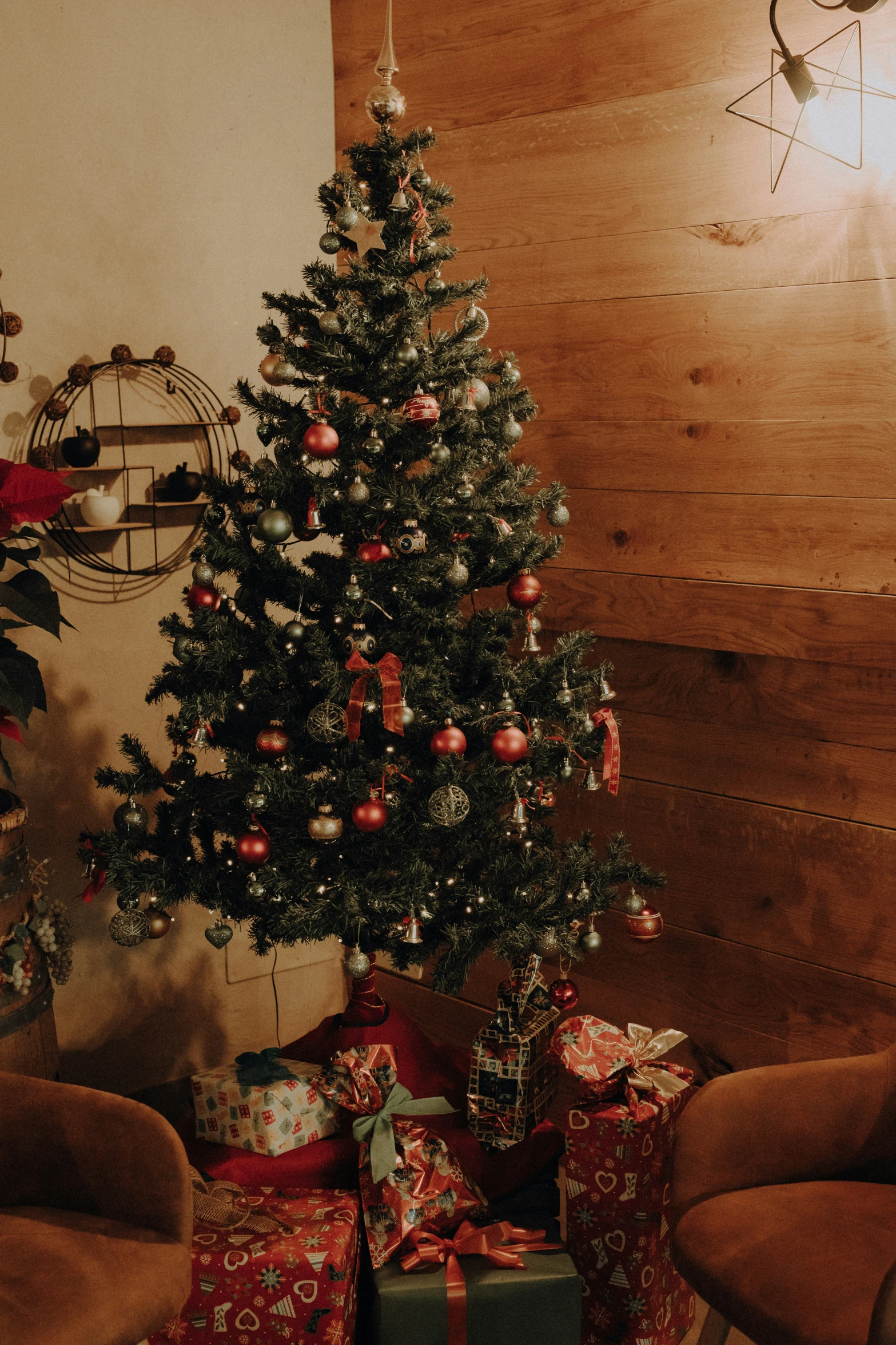 a living room with a christmas tree, presents and gifts under the eave