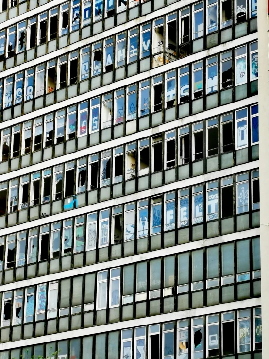 several windows in a large office building are opened