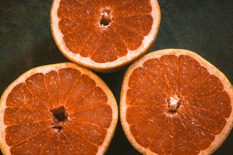 four gfruits have been cut into halves