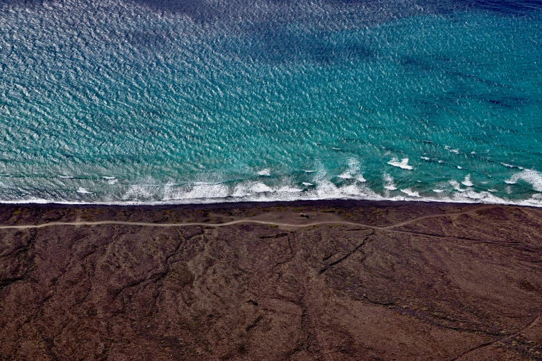 an aerial view of a body of water, with land and water in the foreground