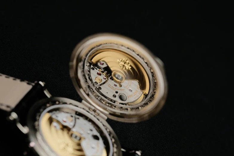 an old watch is spinning its gears away from the camera