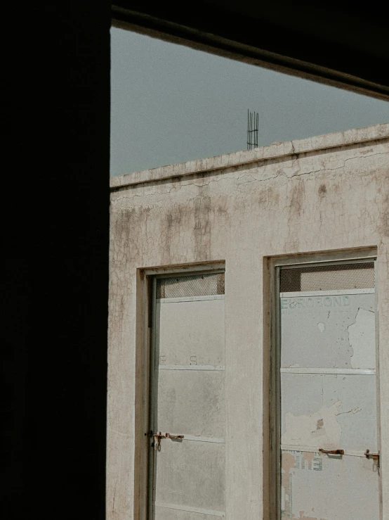 a bird perched on the roof of an old building