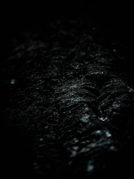 a closeup of black background with small drops of water