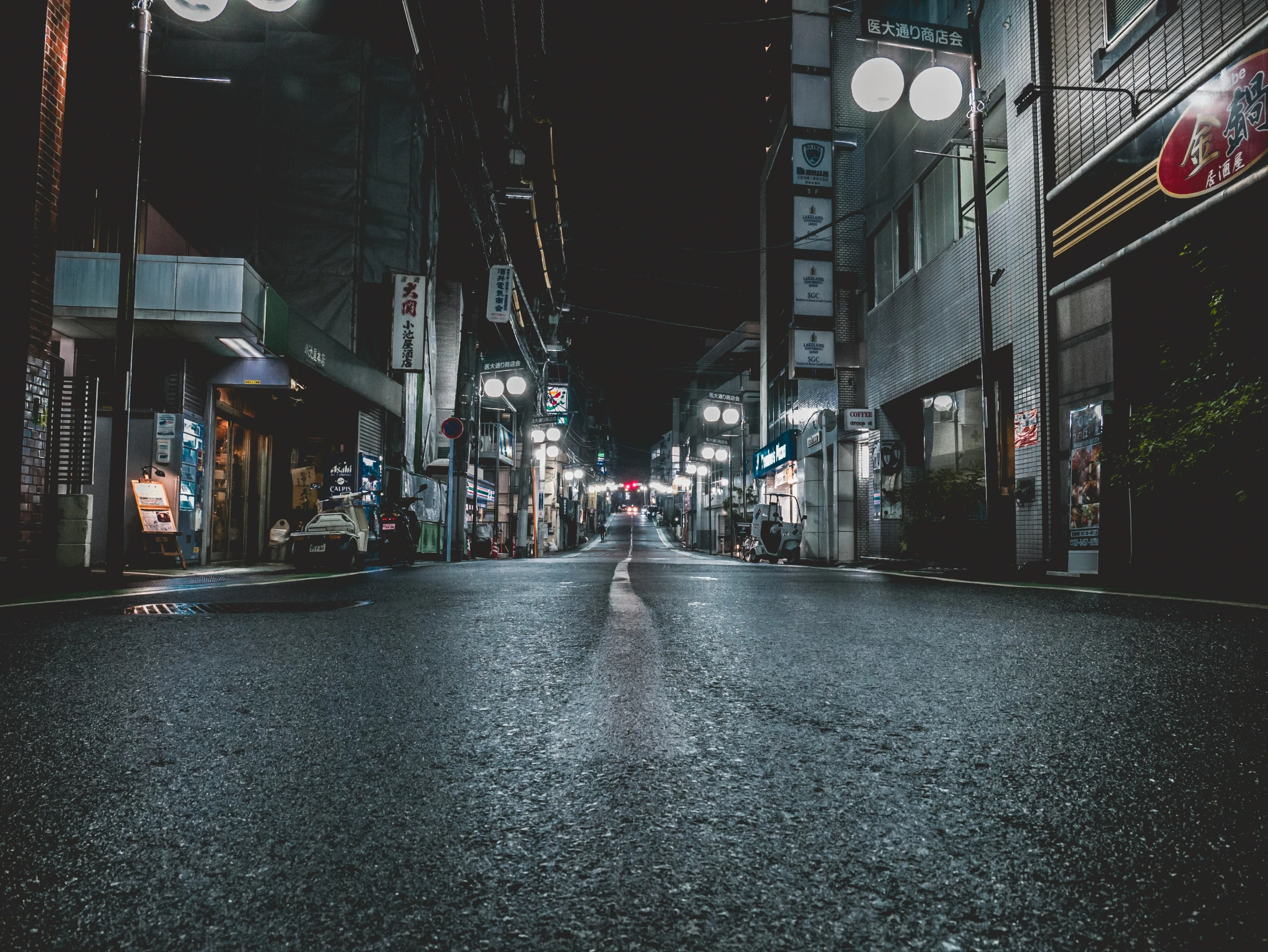 an empty city street is pictured at night