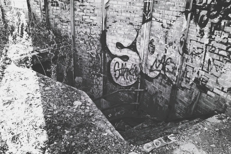 black and white pograph of a hole with graffiti