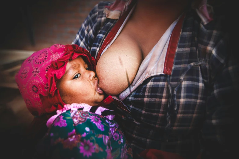 an overweight woman kissing a young child