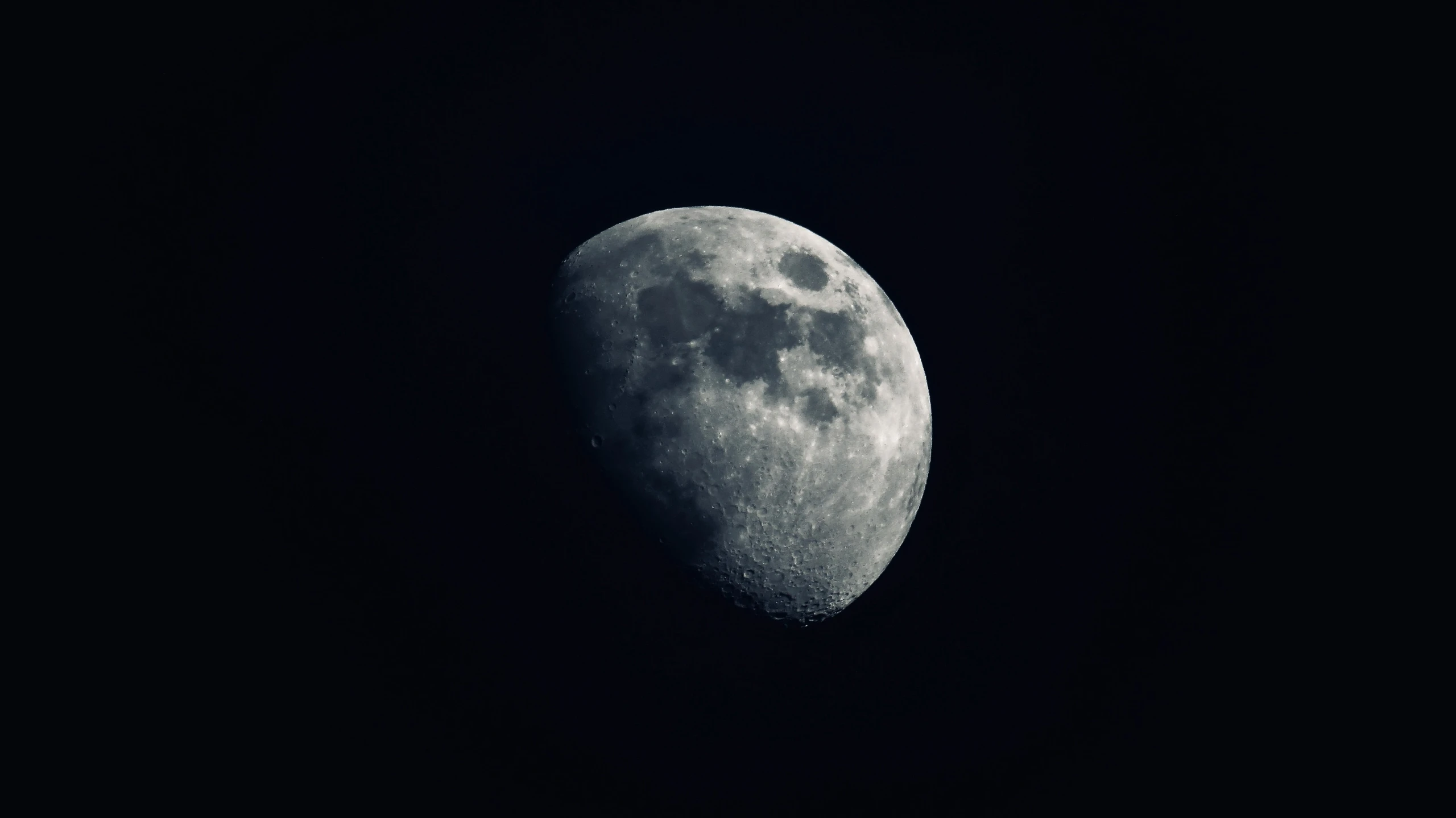 a half - moon on a dark night, with a very visible face