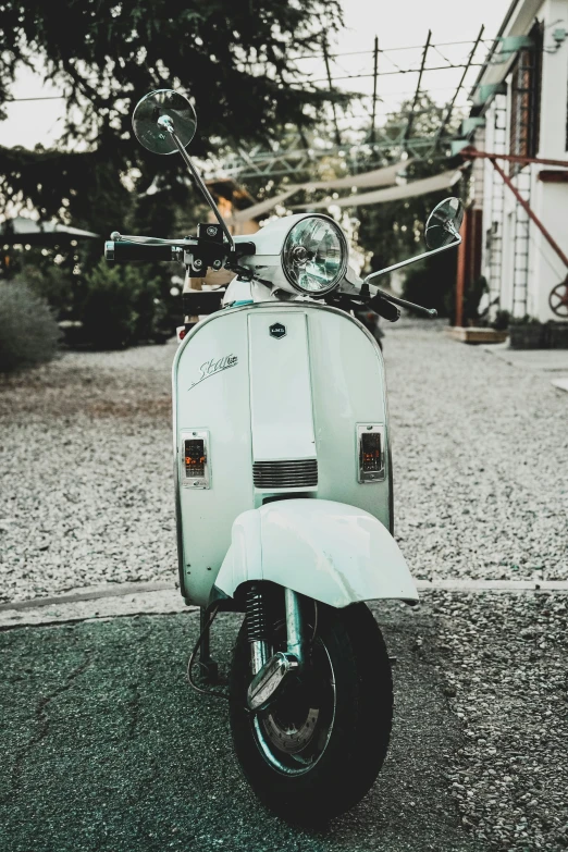 a scooter parked on the street next to some houses