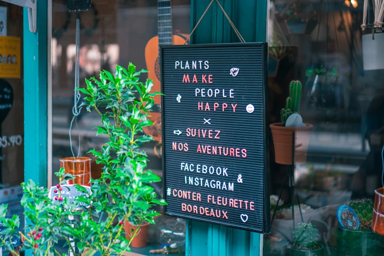 a storefront window that has an electronic sign hanging